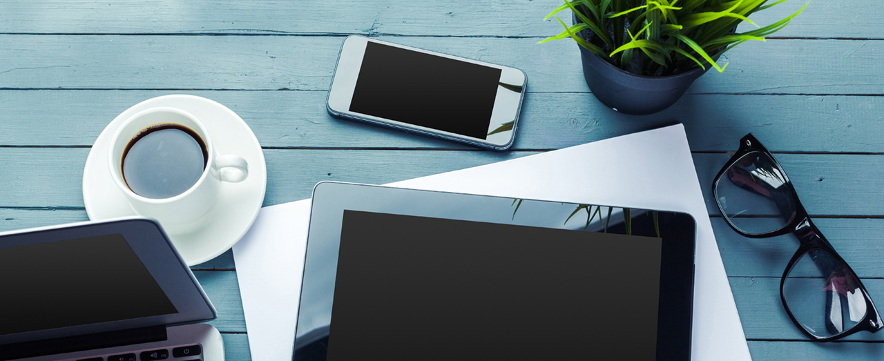 smartphone and other technology supplies with cup of coffee