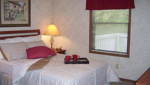 interior of the room, with queen size bed and night lamp